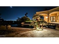 Night view of a luxurious pool and patio area at 4836 E White Gates Dr, Phoenix, AZ 85018