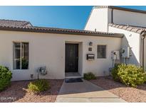 Exterior view of charming single-story home with dark door at 1116 E Belmont Ave, Phoenix, AZ 85020