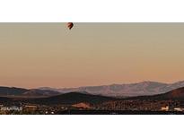 Hot air balloon over mountain and city views at 2549 W Shinnecock Way, Anthem, AZ 85086