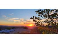 Stunning sunset view over the neighborhood rooftops at 2549 W Shinnecock Way, Anthem, AZ 85086