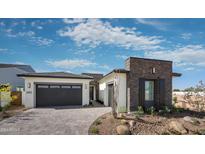 Modern home exterior with stone accents and a two-car garage at 1417 E Cherrywood Pl, Chandler, AZ 85249