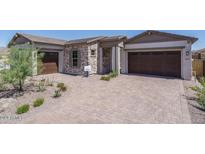 Two-car garage and front yard landscaping at 18624 W Cathedral Rock Dr, Goodyear, AZ 85338