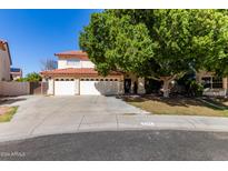 Beautiful two-story home with a three-car garage and lush landscaping at 5702 W Windrose Dr, Glendale, AZ 85304