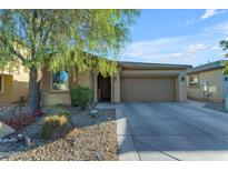 Single story home with a two-car garage and desert landscaping at 44395 W Bailey Dr, Maricopa, AZ 85138