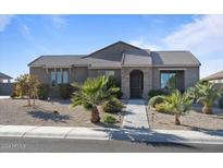 One-story house with a walkway leading to the entrance at 27700 N Silverleaf Rd, San Tan Valley, AZ 85143