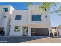 Modern two-story home with sleek design and dark garage door at 2130 E Turney Ave # 4, Phoenix, AZ 85016