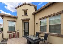 Tan house exterior with courtyard and fire pit at 56 E Camellia Way, Queen Creek, AZ 85140