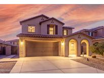 Two-story house with a two-car garage, arched entryway and desert landscaping at 2660 S 172Nd Dr, Goodyear, AZ 85338