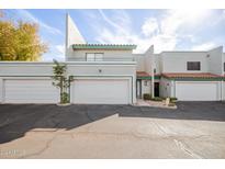 Two-story stucco townhouse with attached garage and front patio at 6705 W Orchid Ln, Peoria, AZ 85345