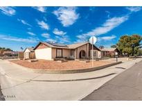 Ranch-style home with landscaped front yard and solar panels at 9618 N 66 Dr, Glendale, AZ 85302