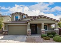 Two-story house with a green facade, stone accents, and a landscaped yard at 9723 E Torino Ave, Mesa, AZ 85212