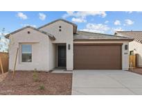 Exterior elevation of a single-story home with a two-car garage and desert landscaping at 23379 W Albeniz Pl, Buckeye, AZ 85326