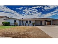 Ranch-style home with carport and well-maintained landscaping at 887 W Shannon St, Chandler, AZ 85225