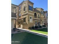 Tan two-story townhome with landscaping at 158 W Commerce Ct, Gilbert, AZ 85233