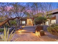 Spanish style home with stone steps, desert landscaping, and soft evening lighting at 36600 N 50Th St, Cave Creek, AZ 85331