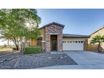 Single-story home with stone accents and a two-car garage at 4742 S Twinleaf Dr, Gilbert, AZ 85297