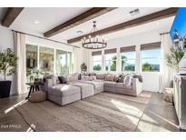 Bright and spacious living room with exposed wooden beams and large windows at 11288 N San Clemente St, Surprise, AZ 85388