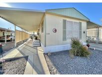 Mobile home exterior with covered porch and landscaped area at 303 S Recker Rd # 110, Mesa, AZ 85206