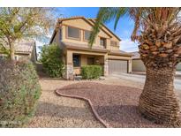 Two-story house with a landscaped front yard and double-car garage at 10468 W Palm Ln, Avondale, AZ 85392