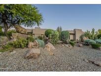 Landscaped front yard with desert plants and large rocks at 24005 N 45Th Dr, Glendale, AZ 85310