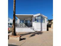 Mobile home with covered porch and carport at 1318 W Chesapeake Dr, Apache Junction, AZ 85119