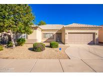 One-story house with light-colored exterior, attached garage, and well-maintained landscaping at 5621 S 27Th St, Phoenix, AZ 85040