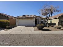 One-story home with a tile roof and two-car garage at 5020 S 25Th Ave, Phoenix, AZ 85041