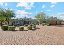 Luxury home with a circular driveway and landscaped front yard at 25210 N 90Th Way, Scottsdale, AZ 85255