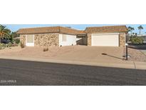 Brick ranch home with a single car garage and landscaped yard at 17841 N Willowbrook Dr, Sun City, AZ 85373