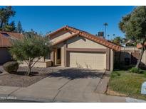 Tan two-car garage home with a terracotta tile roof at 2164 S Catarina --, Mesa, AZ 85202