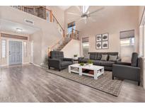 Bright living room with hardwood floors, high ceilings, and a stylish seating area at 21357 N Liles Ln, Maricopa, AZ 85138