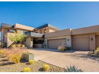 Modern home with three-car garage and desert landscaping at 37200 N Cave Creek Rd # 1002, Scottsdale, AZ 85262