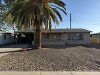 Single story home with a carport and palm tree in the front yard at 2417 W Osborn Rd, Phoenix, AZ 85015