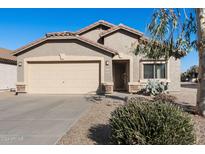 Tan house with a beige garage door and landscaped front yard at 28629 N Zircon Ct, San Tan Valley, AZ 85143