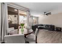 Open concept living and dining area with access to patio at 9550 E Thunderbird Rd # 155, Scottsdale, AZ 85260