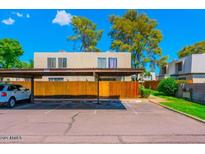 Covered carport parking with wooden fence and a car at 5906 W Townley Ave, Glendale, AZ 85302