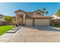 Two-story house with a three-car garage and landscaped lawn at 959 W Myrtle Dr, Chandler, AZ 85248