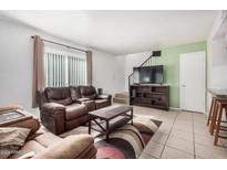 Living room with leather couches and a large TV at 600 S Dobson Rd # 18, Mesa, AZ 85202