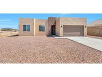 Front view of a newly built house with a gravel yard at 9121 W Debbie Ln, Arizona City, AZ 85123