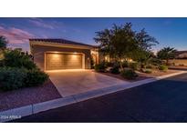 House exterior at night with a two-car garage at 13431 W Los Bancos Dr, Sun City West, AZ 85375