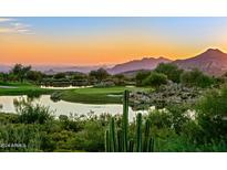 Scenic aerial view of golf course community at sunset at 10755 E Stoney Ln, Scottsdale, AZ 85262