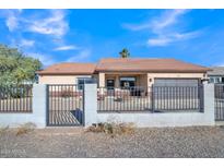 House exterior with gated driveway and landscaping at 5514 E Santa Clara Dr, San Tan Valley, AZ 85140