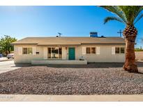 Newly renovated single-story home with a teal door and gravel landscaping at 101 W Shannon St, Chandler, AZ 85225