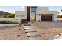 Modern home with a two-car garage and landscaped front yard at 18475 W Eagle Dr, Goodyear, AZ 85338