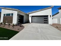 Modern home exterior with two-car garage and landscaped front yard at 3812 W Antelope Way, San Tan Valley, AZ 85144