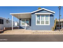 Charming blue exterior with covered porch and landscaping at 7750 E Broadway Rd # 723, Mesa, AZ 85208