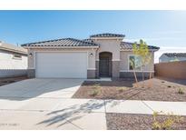 New single-story home with a two-car garage and desert landscaping at 17807 W Encinas Ln, Goodyear, AZ 85338