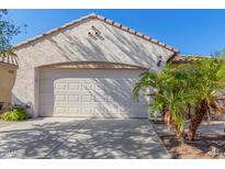 White garage door with desert landscaping at 2208 N Potomac Ct, Florence, AZ 85132