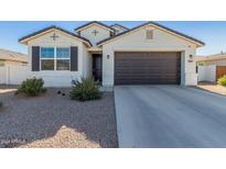 House exterior with two-car garage and landscaping at 36063 W San Alvarez Ave, Maricopa, AZ 85138