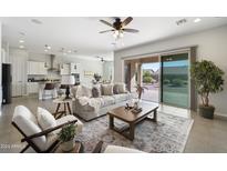 Open-concept living space with a modern sofa and large sliding glass doors at 10609 E Evergreen St, Mesa, AZ 85207